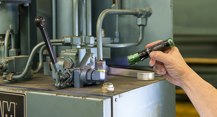 Industrial leak detection kits use fluorescent dye to determine the location of hydraulic fluid leaks.