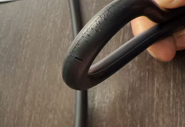 Real-world failure photo shows surface cracking on an O-ring from a field application, illustrating thermal/chemical degradation as described in the article.
